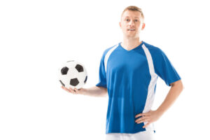 soccer player holding ball